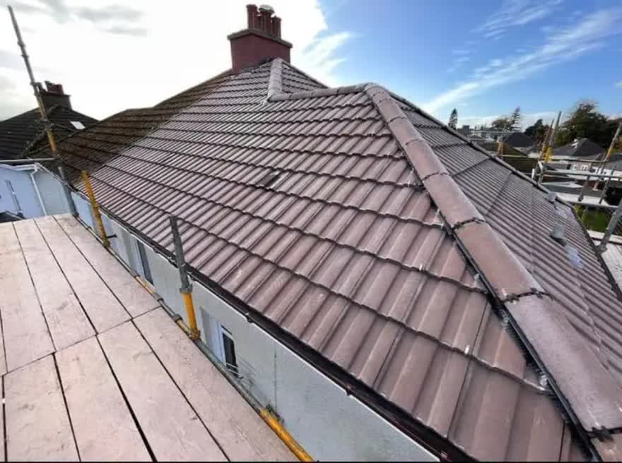 Freshly tiled roof slope with the scaffold boards still down