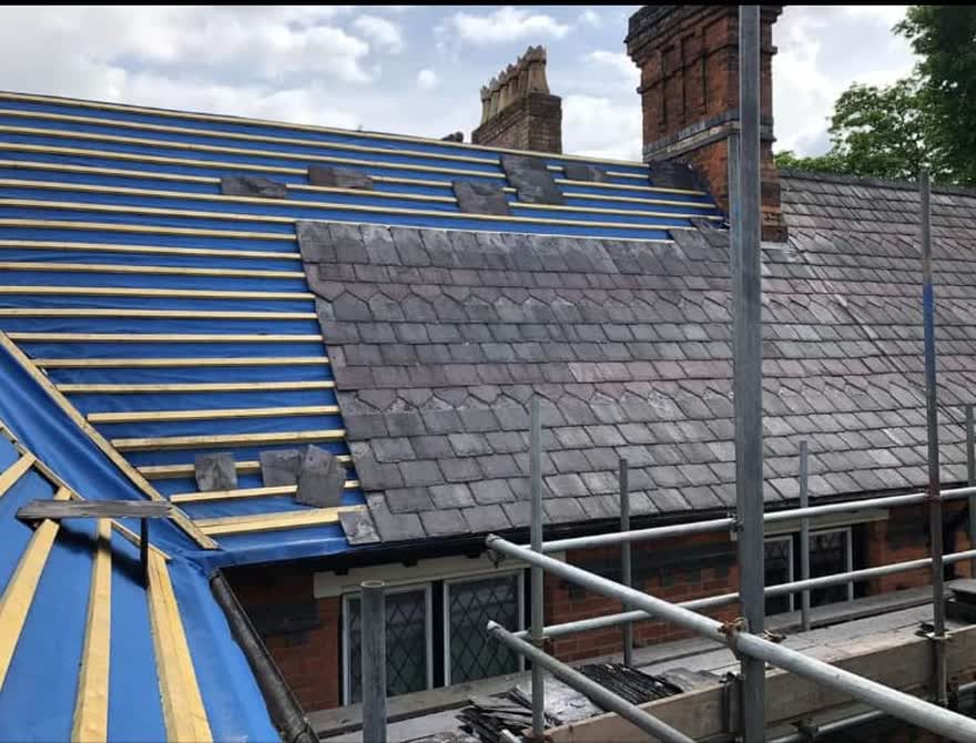 Roof stripped back with the scaffold sheeted before the new covering goes on