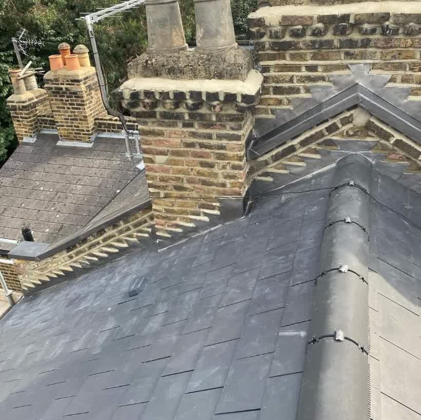 Slate roof and stone chimney stacks on an older property