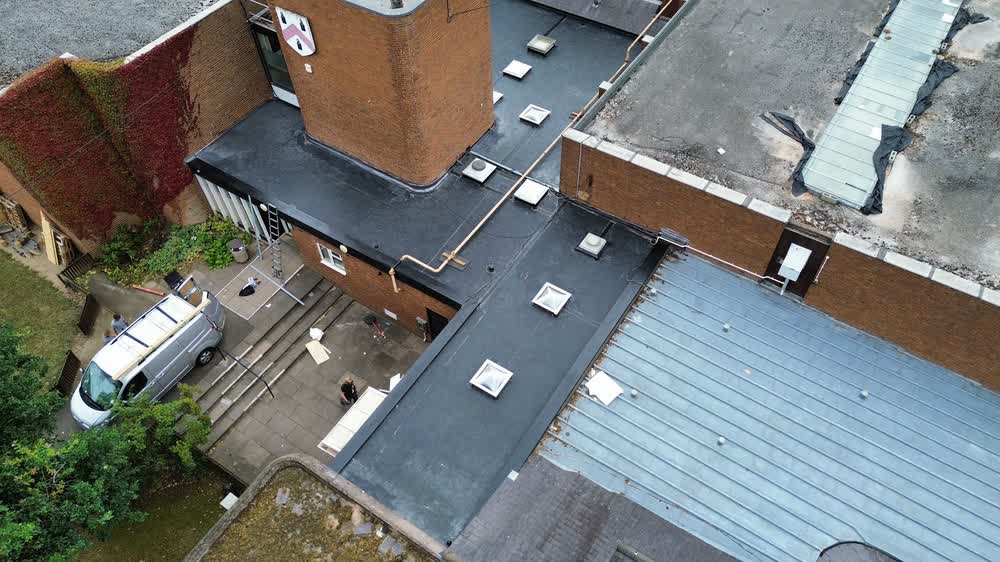 Flat roof running across a terrace of properties, seen from above