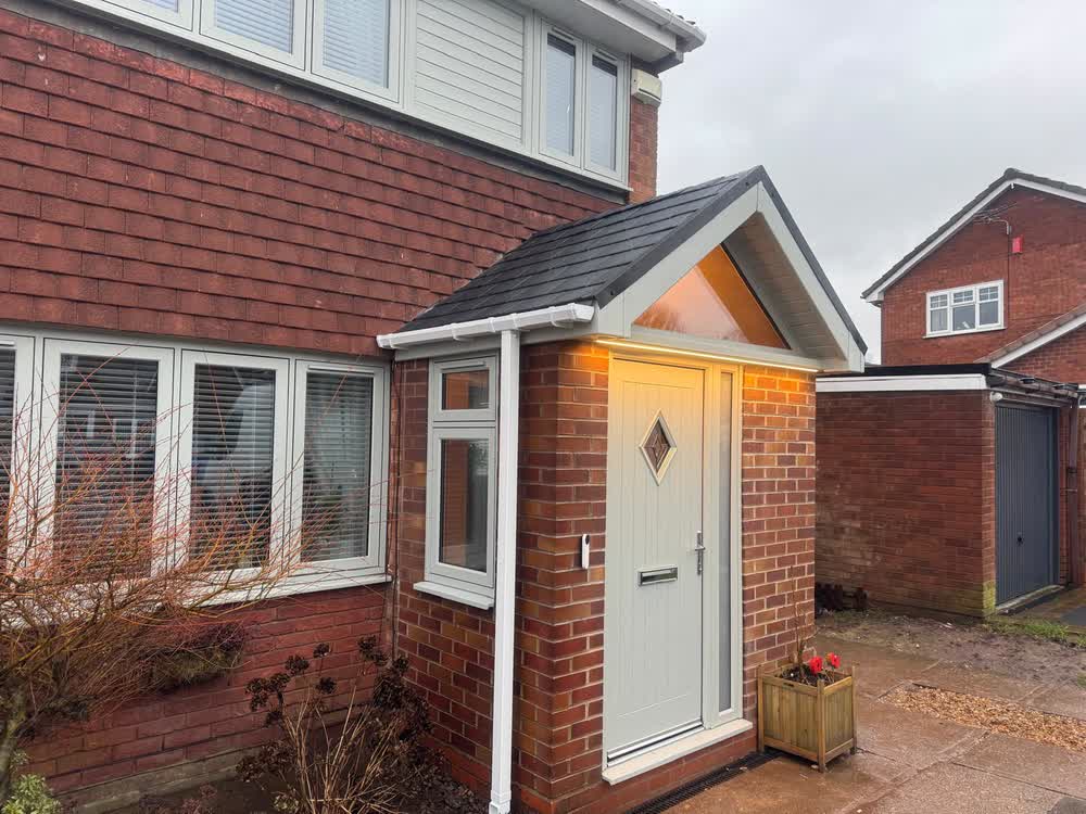 Porch with a new tiled roof and a lit doorway