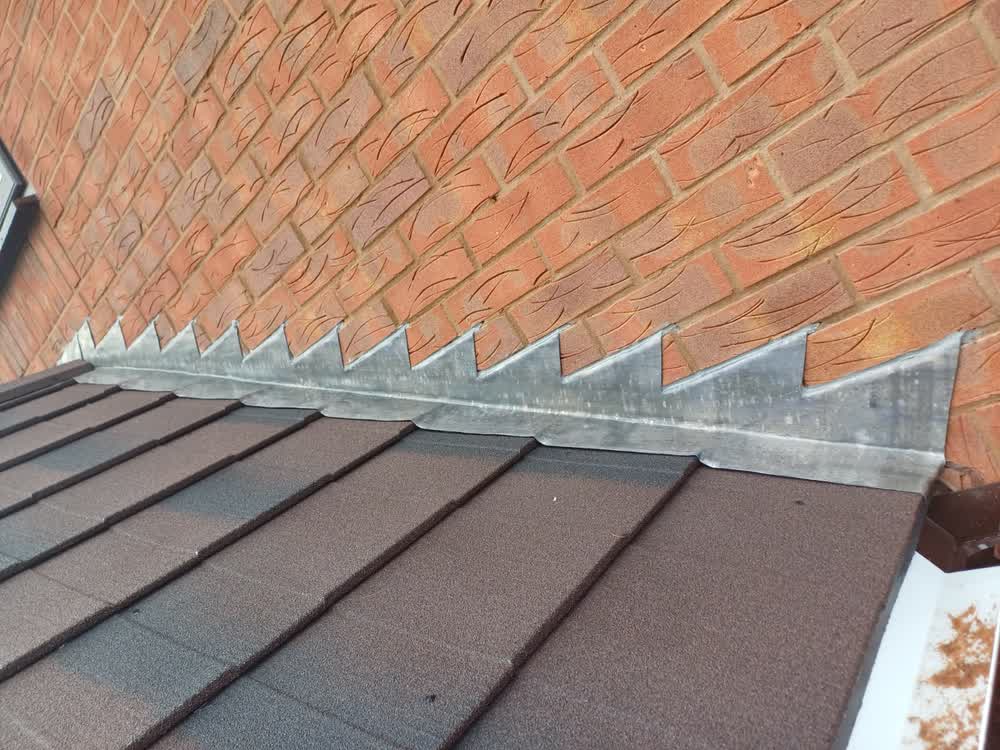 Dry verge where a newly tiled roof meets the brickwork of the house